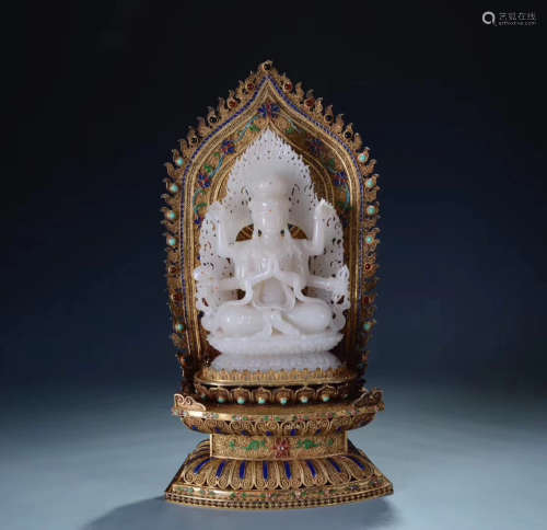 A HETIAN JADE SIX-ARM GUANYIN STATUE WITH GILT SILVER BASE