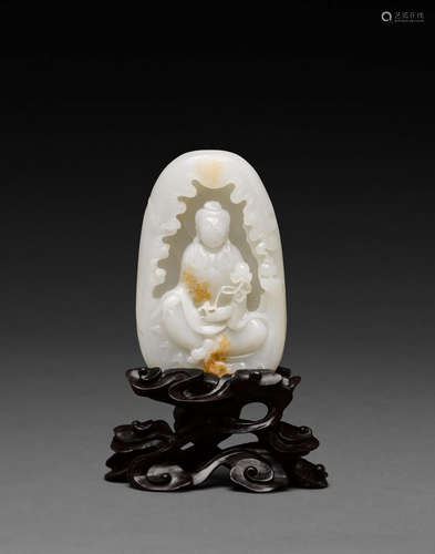 A white jade boulder depicting Guanyin