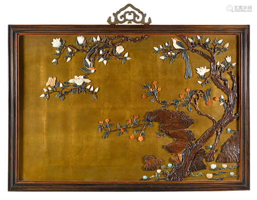 A framed giltwood wall panel with colored stone and wood overlay decoration