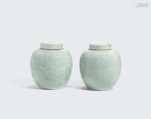 Qianlong marks, 19th century A pair of celadon glazed dragon jars and covers