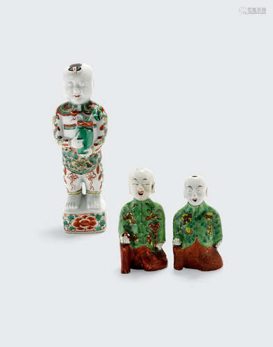 A group of three famille verte enameled figures of boys