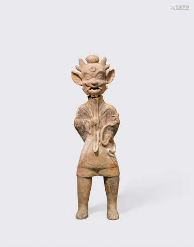 Eastern Han dynasty (25-220 CE) A standing grey pottery figure of a tomb guardian, zhenmuyong