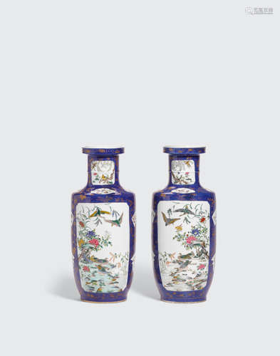 A pair of powder blue ground rouleau vases with famille rose enamel reserves