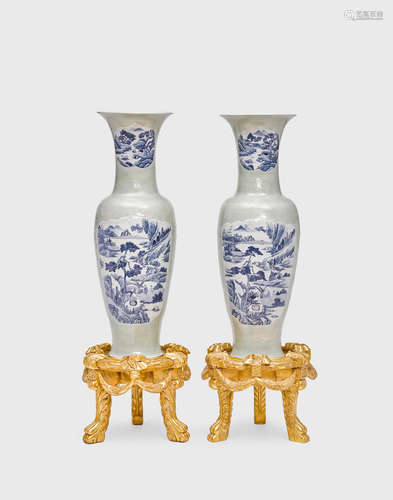 A pair of massive celadon glazed vases with underglaze blue landscape reserves