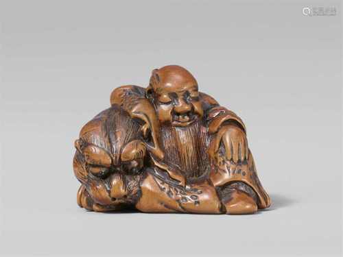 A charming boxwood netsuke possibly of Bunkan Zenshi. Early 19th centurySleeping and seated at