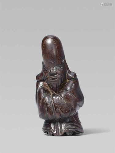 A wood netsuke of Fukurokuju, by Tamahiko. 19th centuryStanding with hands covered by his long robe,