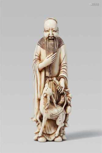 A fine ivory netsuke of Jurôjin. Early 19th centuryThe god stands stroking his long beard and