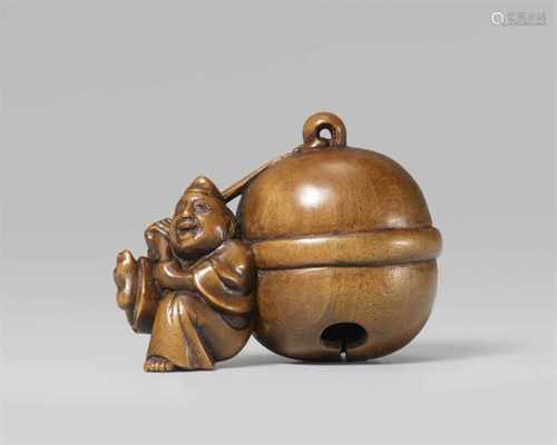 A boxwood netsuke of a laughing shrine attendant with a huge bell. Early 19th centuryWearing an