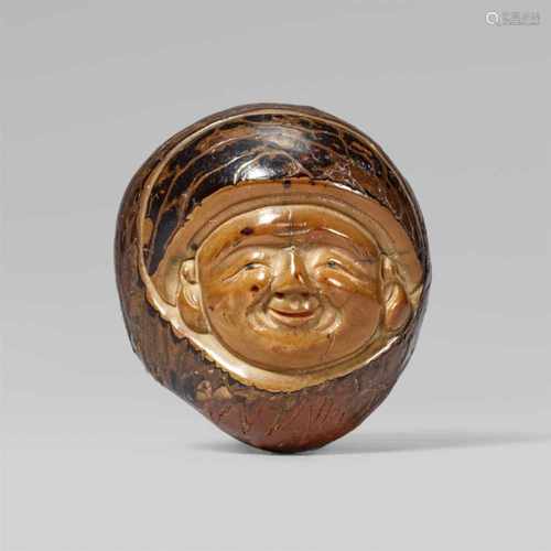 A fine large corozo nut netsuke of a god of good luck, by Masaharu. Mid-19th centuryCarved with