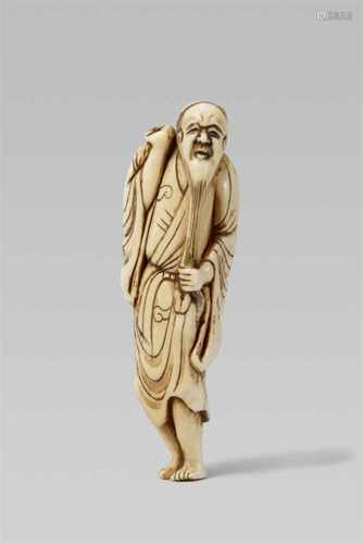 An ivory netsuke of a bearded sennin. Early 19th centuryThe long-haired and bearded sennin stands