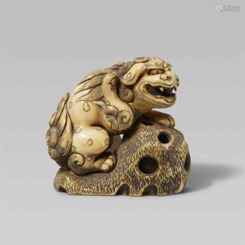 A good large ivory netsuke of a shishi. Early 19th centuryStanding by a rock with a flat base, one