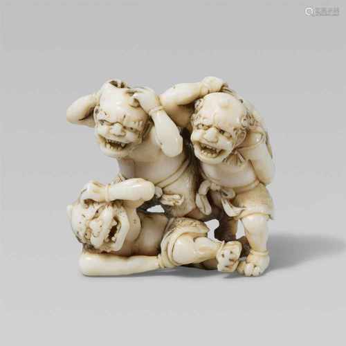 An amusing Edo school ivory netsuke of three oni at setsubun, by Gyokkôsai. Mid-19th