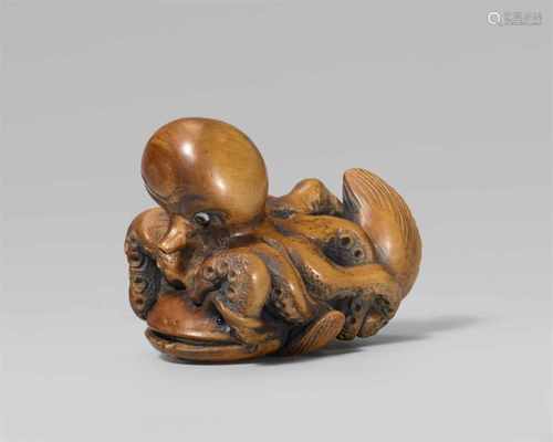 An amusing boxwood netsuke of an octopus riding on a catfish, by Masakazu. Late 19th