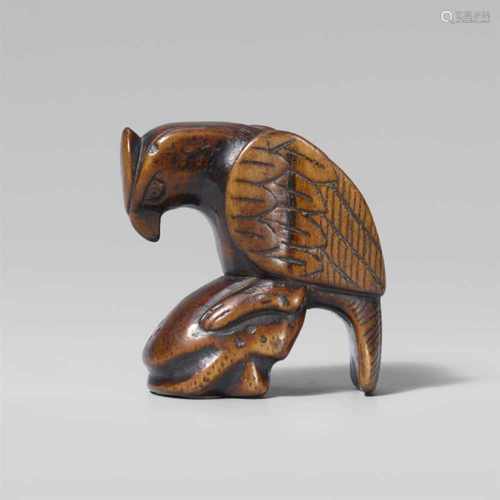 A large boxwood netsuke of an eagle. Early 19th centuryPerched on a rock, the head lowered, the