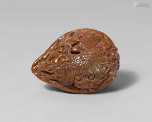 A fine large walnut netsuke of cranes. Mid-19th centuryBoth halves of the nut carved partly in