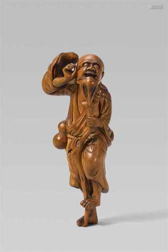 A boxwood netsuke of a bearded Tekkai Sennin. Late 18th/early 19th centuryThe long-haired and