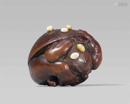 An amusing wood netsuke of an oni at setsubun, by Ikka? First half 19th centuryA muscular oni