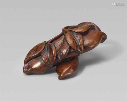 A wood netsuke of two bean pods. 19th centuryPlaced across each other, with two leafy twigs lying on