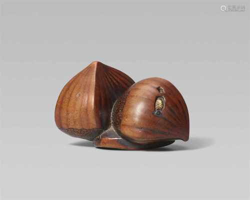 A boxwood netsuke of three chestnuts. Early 19th centuryOne upright and one horizontally placed