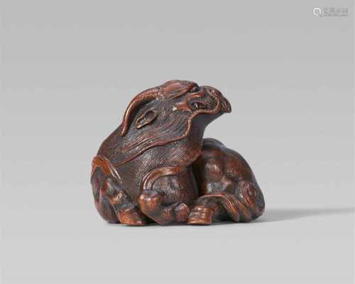 A very fine Nagoya school wood netsuke of a kirin, by Ikkan. Mid-19th centuryReclining, the head