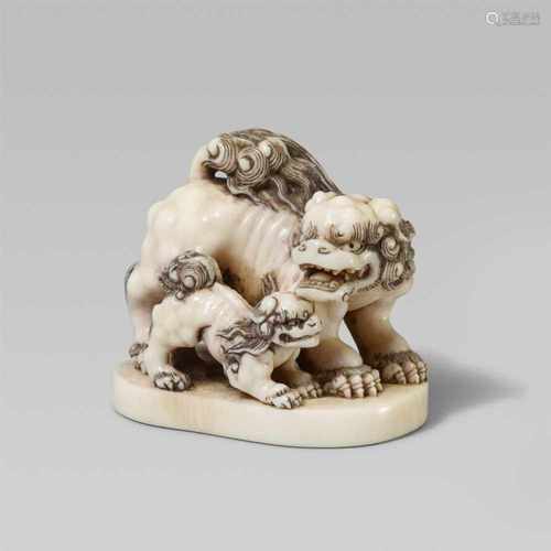 A very good ivory netsuke of two bushy-haired shishi. Mid-19th centuryStanding on an oval flat base,