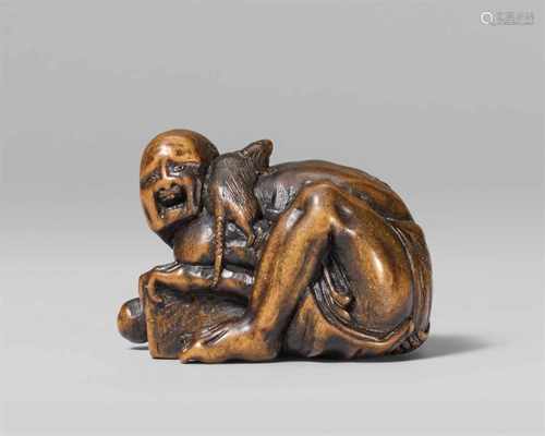 A small boxwood netsuke of a disappointed rat catcher, by Ichimin. Mid-19th centuryCrouching over