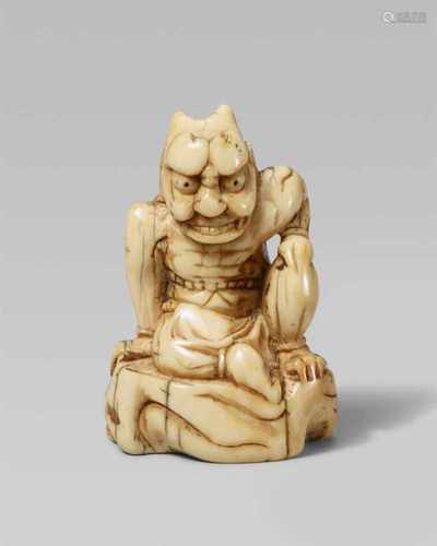 An unusual ivory netsuke of a large oni. 18th centurySeated with a fierce expression and big horns