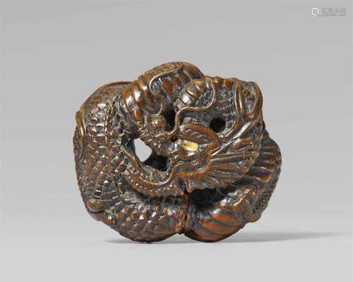 A good Tanba school wood netsuke of a dragon, by Toyokazu. Mid-19th centuryCoiled into an oval ryûsa