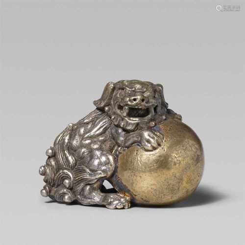 A fine small silver netsuke of a shishi. Mid-19th centurySeated, the head turned to the right,