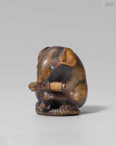 A large boxwood netsuke of a rat with a scroll, by Shigemasa. Mid-19th centurySitting on its tail, a