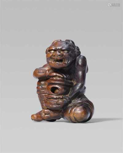 A rare and interesting wood netsuke of an oni with a reliquary, by Awataguchi. First half 19th