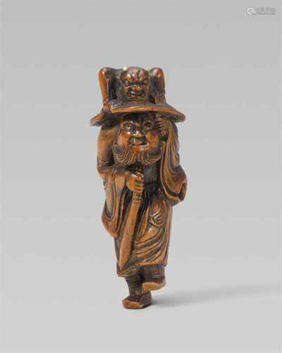 A boxwood netsuke of Shôki. Early 19th centuryThe demon queller stands on one leg with wind-swept