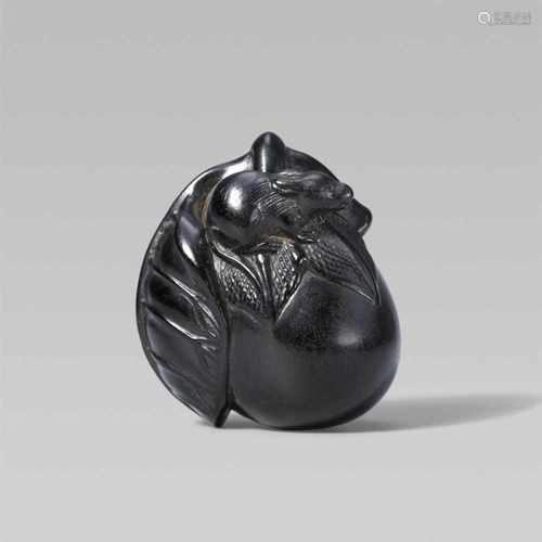 A black wood netsuke of an eggplant and a small rat. First half 19th centuryA rat sits on top of