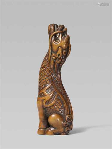 An attractive boxwood netsuke of a kirin. 19th centurySeated on its haunches, howling and raising