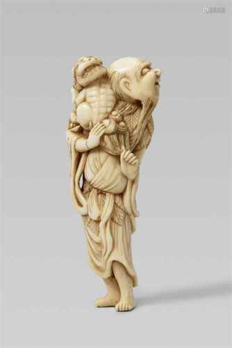 An ivory netsuke of a sennin with a shishi. 18th centuryThe long-haired and bearded sennin stands