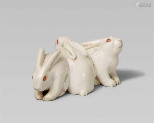 An attractive ivory netsuke of three rabbits. Mid-19th centurySeated close together with heads