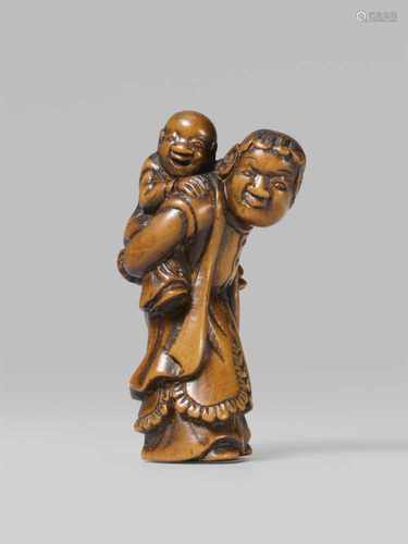 A boxwood netsuke of a Dutchman with a child. Early 19th centurySlightly bent forward under the