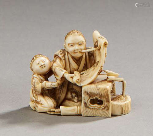 JAPONNetsuke figurant un lettré et son enfant. ...