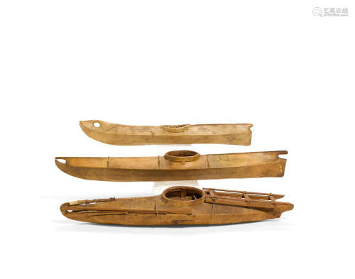Three Eskimo model kayaks