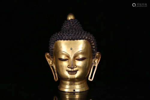 A TIBETAN GILT BRONZE SHAKYAMUNI HEAD