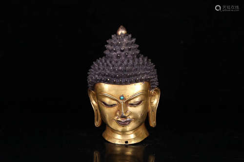 A TIBETAN GILT BRONZE SHAKYAMUNI HEAD