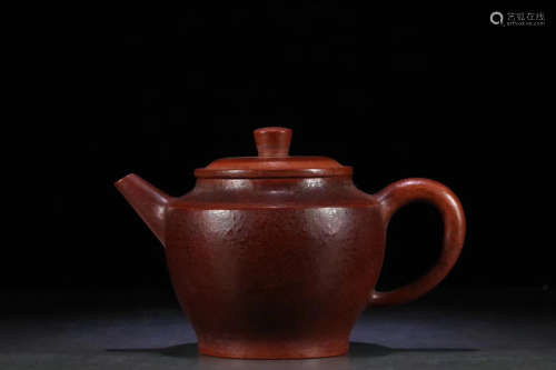 AN OLD PURPLE CLAY TEAPOT