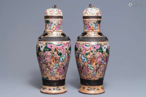 A pair of Chinese Nanking famille rose vases and covers, 19th C.