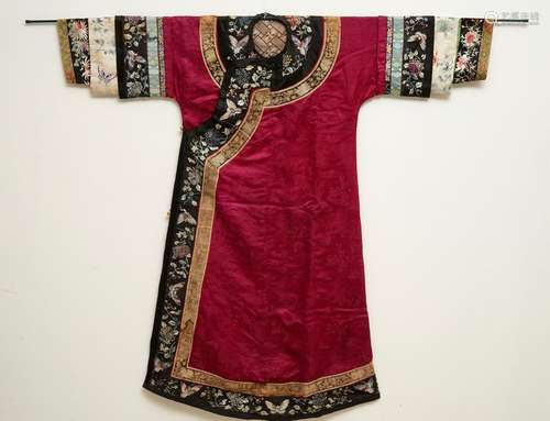 A Chinese informal Manchu embroidered silk pink-ground women's robe, 19th C.