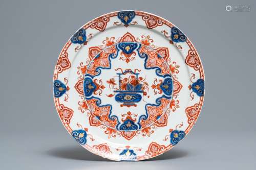 A Dutch Delft doré Imari-style plate with a flower basket, 18th C.