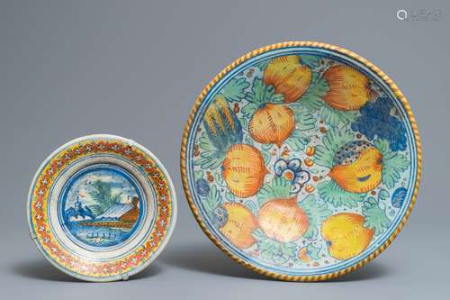 A polychrome Dutch maiolica pomegranates dish and a landscape plate, 17th C.