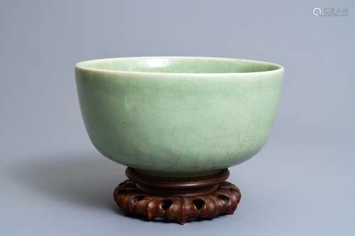 A Chinese celadon bowl on wooden stand, Kangxi/Yongzheng