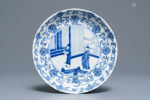 A Chinese blue and white moulded plate with figures on a terrace, Kangxi mark and of the period