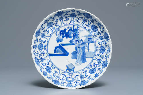 A Chinese blue and white moulded plate with figures on a terrace, Kangxi mark and of the period