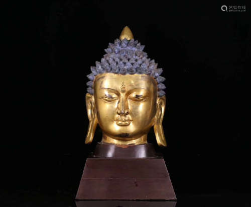 A GILT BRONZE MOLDED BUDDHA HEAD FIGURE